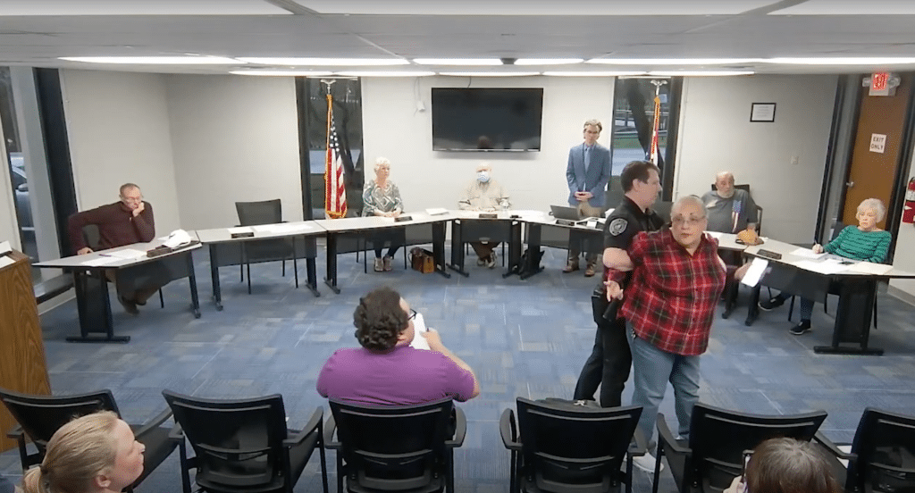 A man arresting a woman.